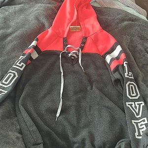 this is a grey, hot pink and white sweat shirt the brand is bobbie brooks ladies